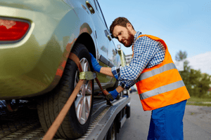 Tow truck assisting broken down car